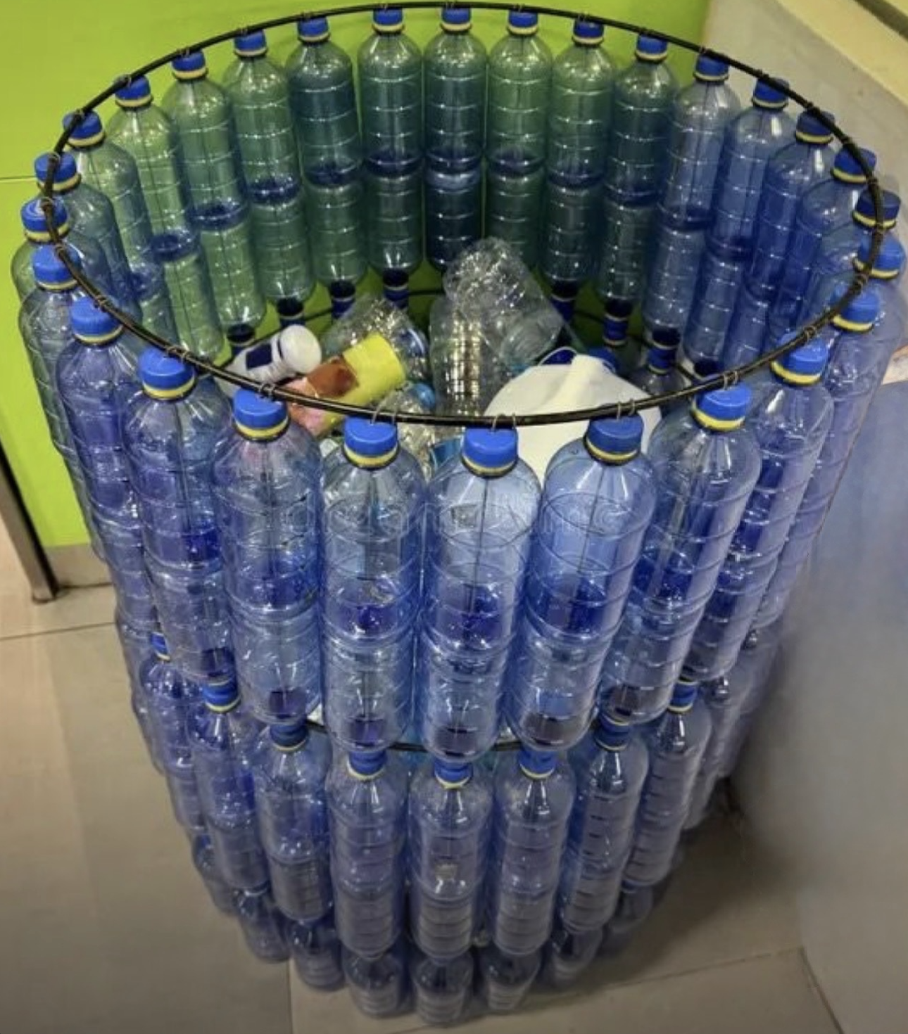 Large trash bin built from recycled plastic bottles