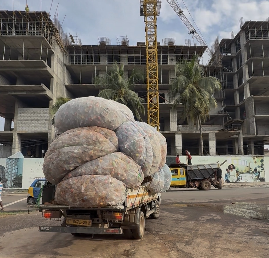 Truck loaded with large bags of collected plastic bottles in Accra